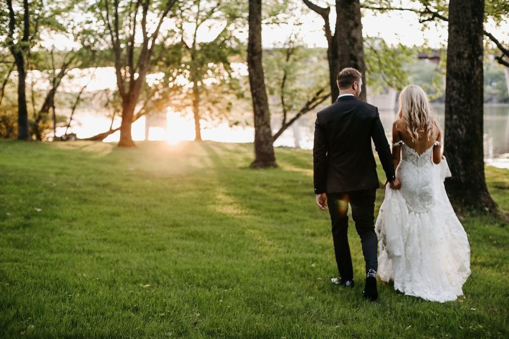 Brielle and alec bride and groom portrait in the lakefront lawn of the estate at cherokee dock