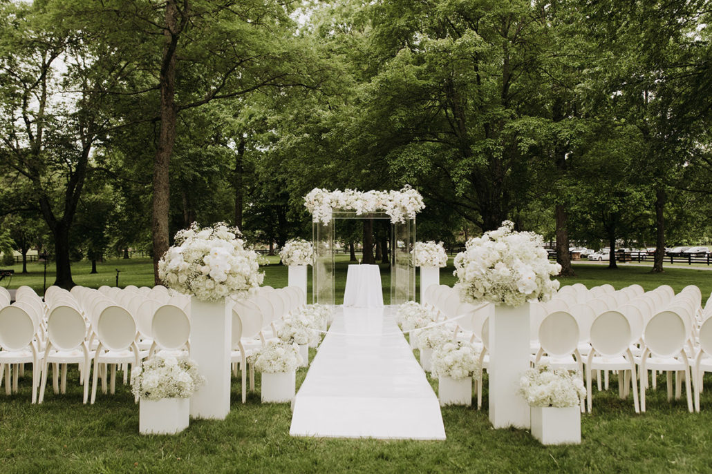 acrylic and white ceremony set up under willow oak canopy