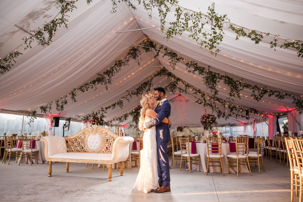 bride and groom share a solo dance in their tented wedding reception