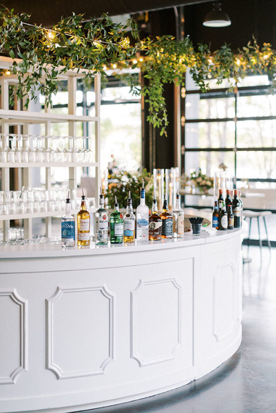 white round bar decorated with hanging greenery