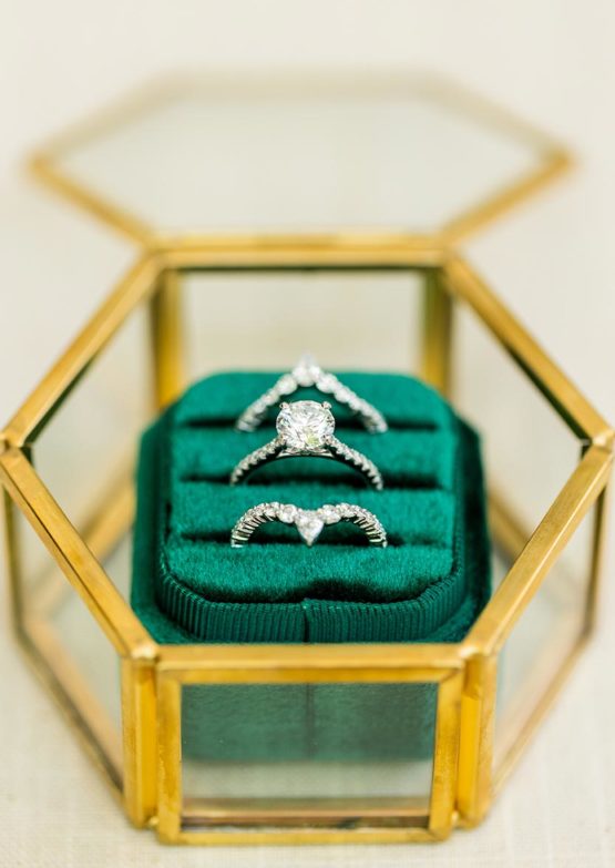 Wedding rings in a gold and emerald case
