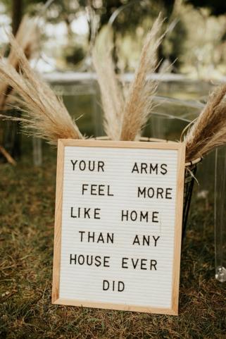Sweet quotes on letterboards with pampas grass for aisle decor