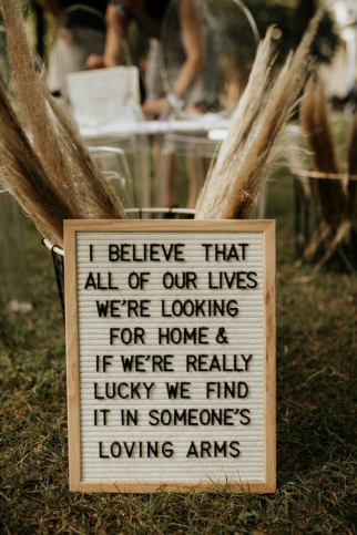 Sweet quotes on letterboards with pampas grass for aisle decor