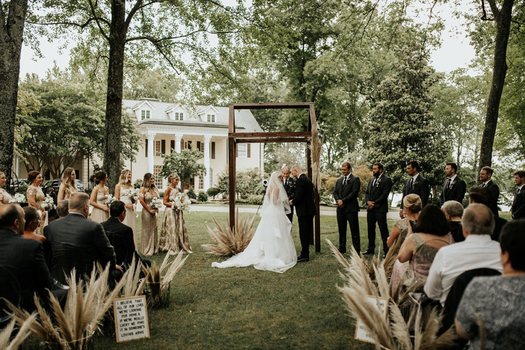 Wedding ceremony under Willow Oak Canopy with view of mansion behind