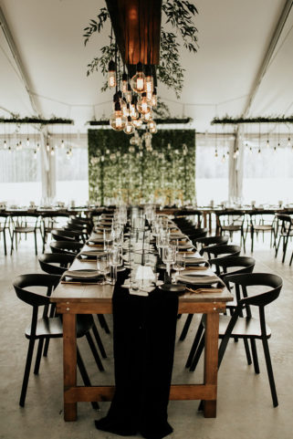 Tablescape decor on Sunset Terrace with mixed light bulbs and greenery hanging above