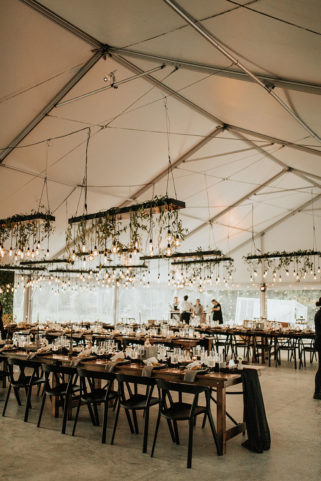 Wedding reception setup on Sunset Terraces with hanging bulbs and greenery