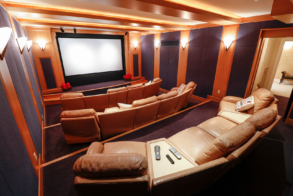 12-person movie theater with large screen inside mansion