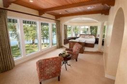 Reba Suite with wall of windows overlooking the lake
