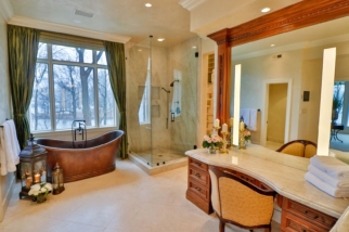 Bathroom of primary suite with copper tub and glass shower