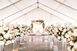 Indian wedding ceremony setup on Sunset Terrace with acrylic flower stands and tall arrangements that lead to the traditional mandap