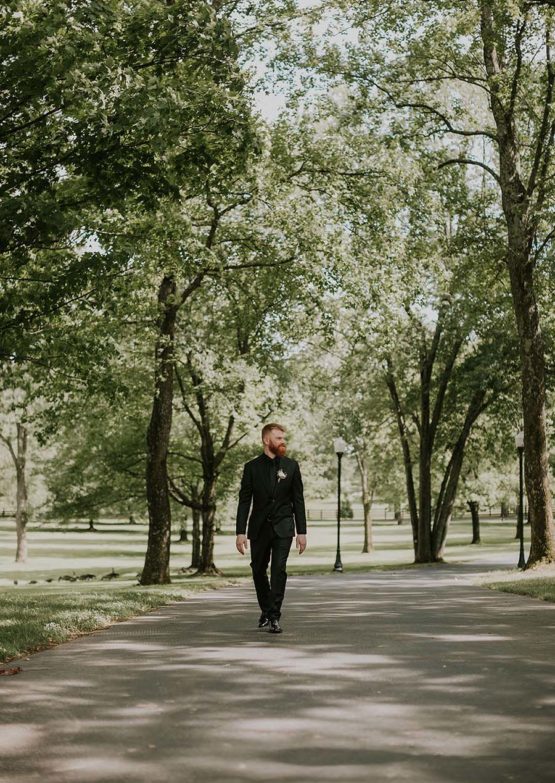 Groom walking down Cherokee Dock's long driveway