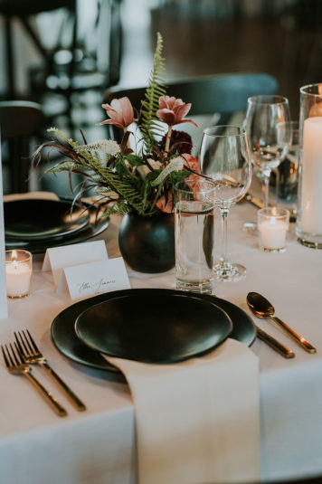 Modern Wedding Reception Table Setting with black flatware