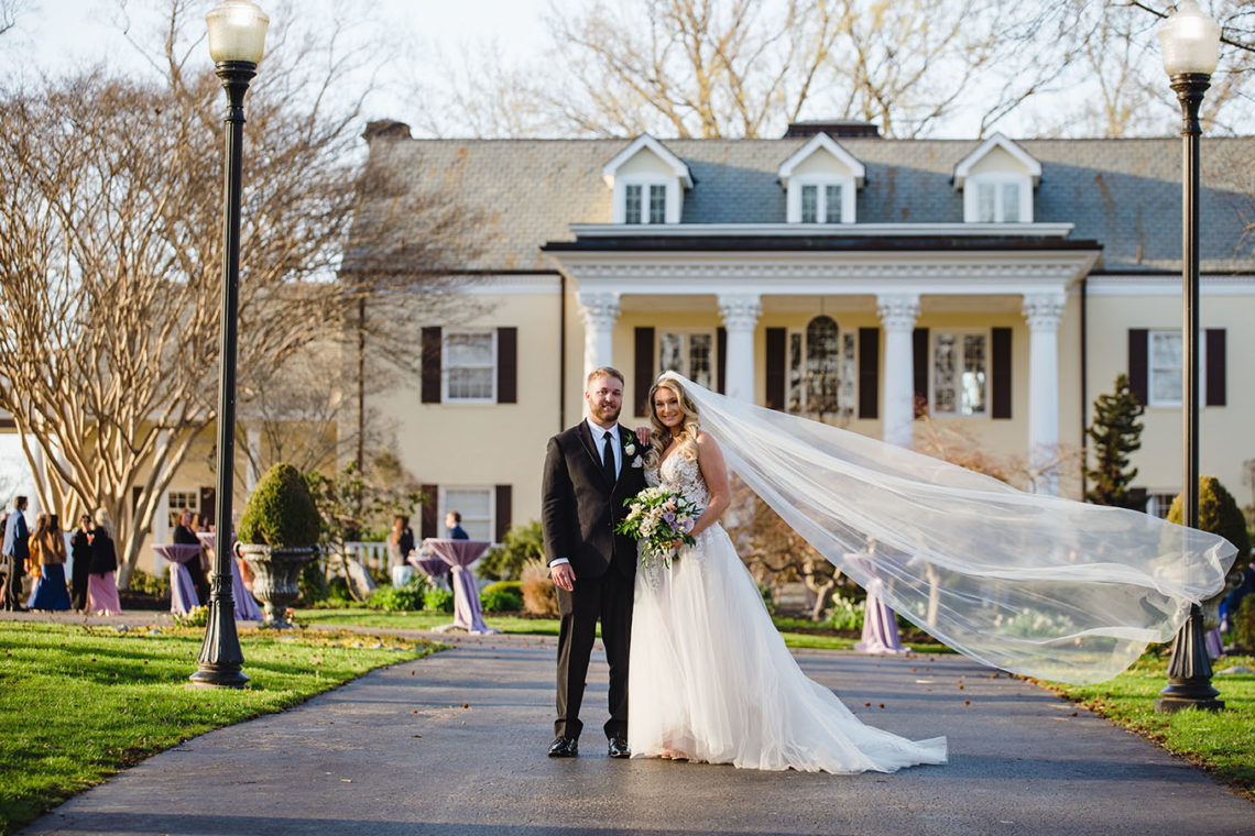 Bride and groom portrait in front of the mansion