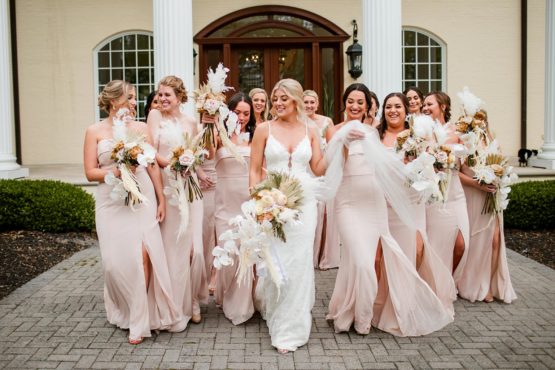 Ella and Her Bridesmaids With Their Bouquets in Front of The Mansion