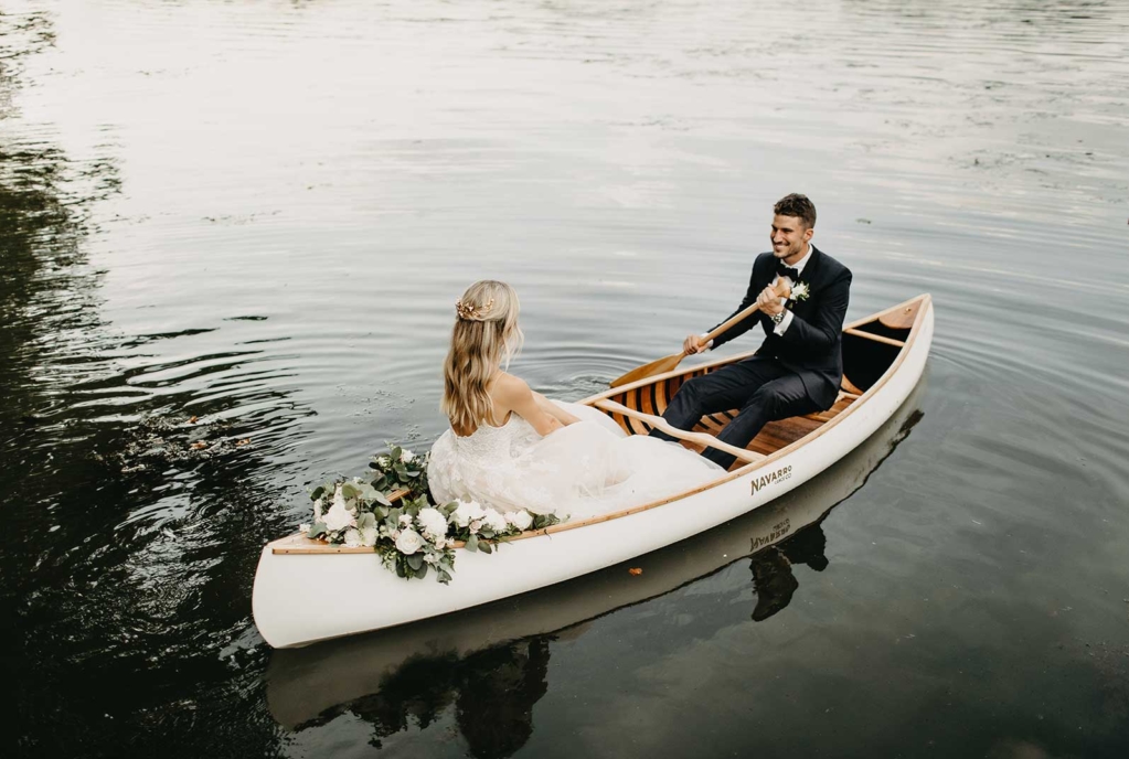 Ellie and Roman rowing in canoe on the lake