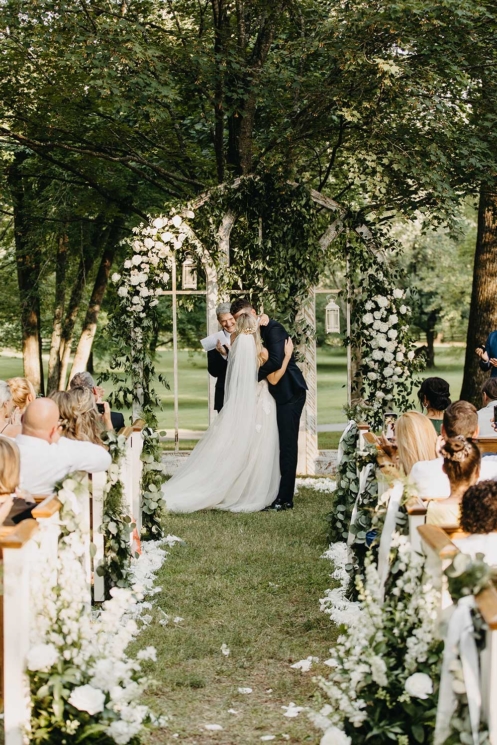 Garden Wedding Ceremony with petal-lined aisle and vintage windows as ceremony backdrop