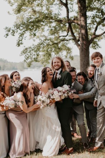 Bride and groom cheer with bridesmaids and groomsmen