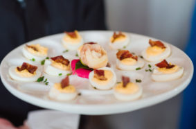 Wedding catering appetizer of bacon-topped deviled eggs