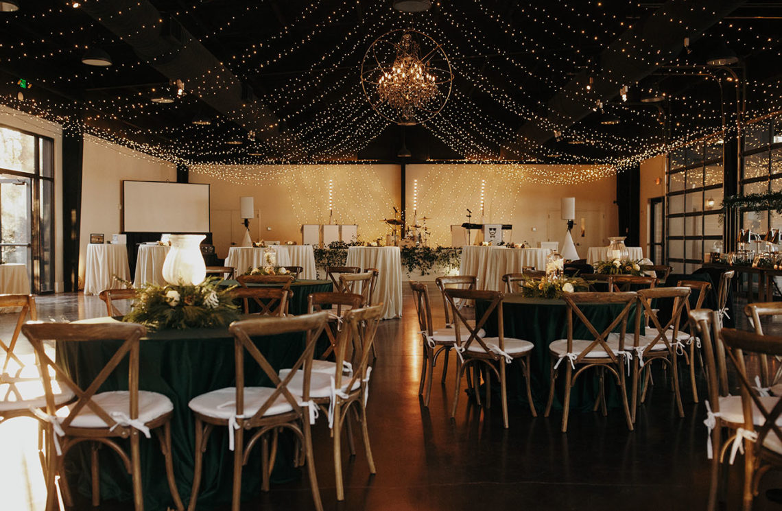 Canopy of string lights over wedding reception table setup inside Lakeview Event Center