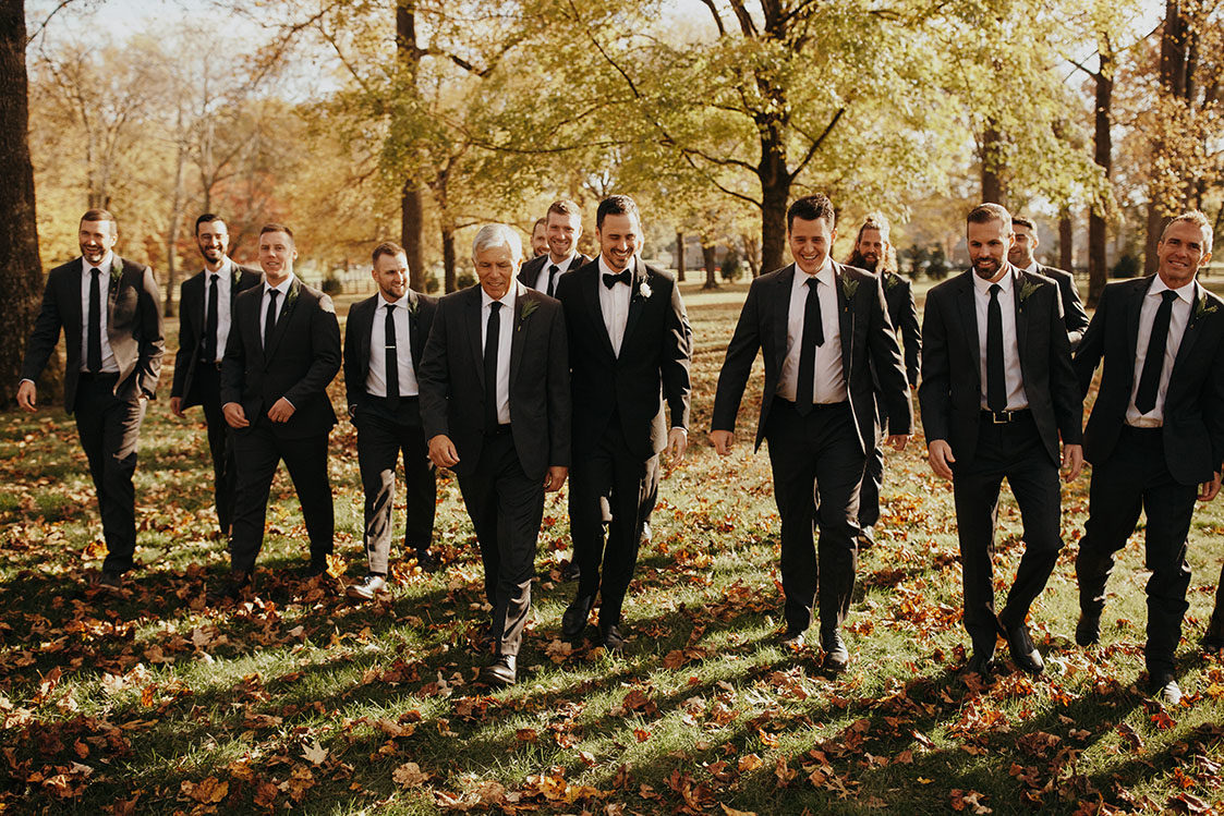 ben with his groomsmen on the lakeside lawn