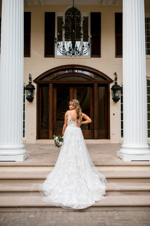 Bride on mansion's front steps