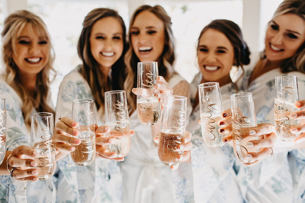 Bride and Bridesmaids Holding Glasses of Champagne