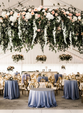 Large romantic hanging floral installation over reception tables on Sunset Terrace