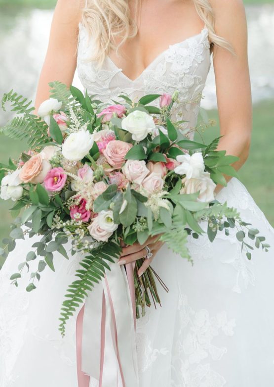 Freeform style bridal bouquet with greenery, white and pink roses