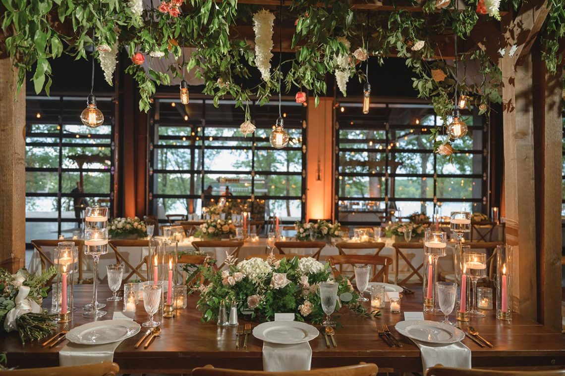 Indoor Garden Trellice Wedding Decor with Whimsical Hanging White Wisteria Flowers with Greenery and Edison Bulb Lighting