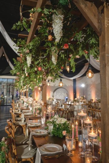 ndoor Garden Trellice Wedding Decor with Whimsical Hanging White Wisteria Flowers with Greenery and Edison Bulb Lighting
