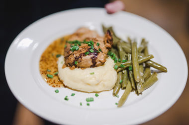 Wedding catering photo of maple mustard chicken breast served over mashed potatoes with green beans