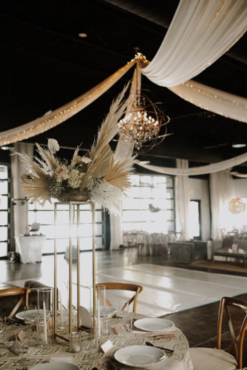boho inspired wedding reception with elevated florals with pampas