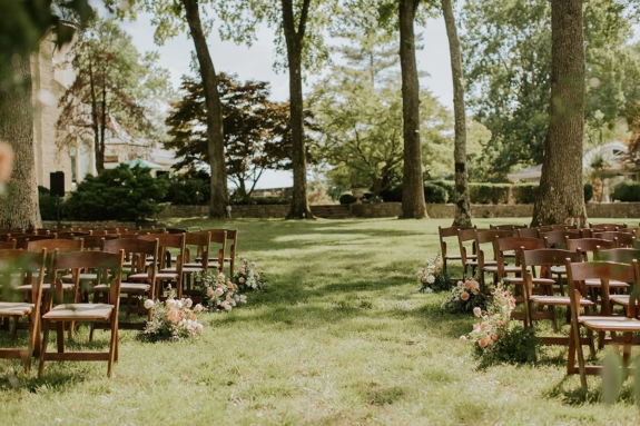 Wedding ceremony chairs on Lakeside Lawn with the mansion in the background