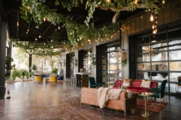 Outdoor lounge area for wedding reception at Lakeview Event Center, decorated with vintage couches and oriental rugs